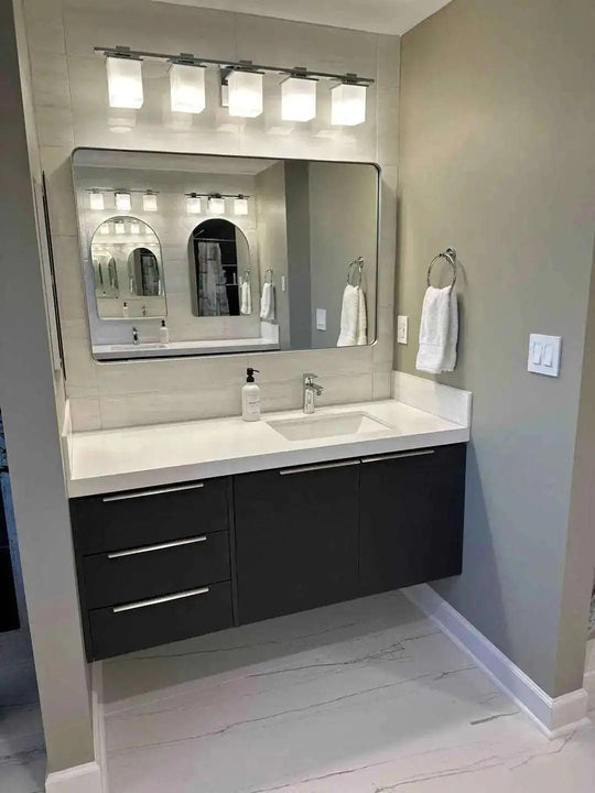 56" custom bathroom vanity. 2 doors, 3 drawers. White quartz countertop mitered. White ceramic undermount sink.