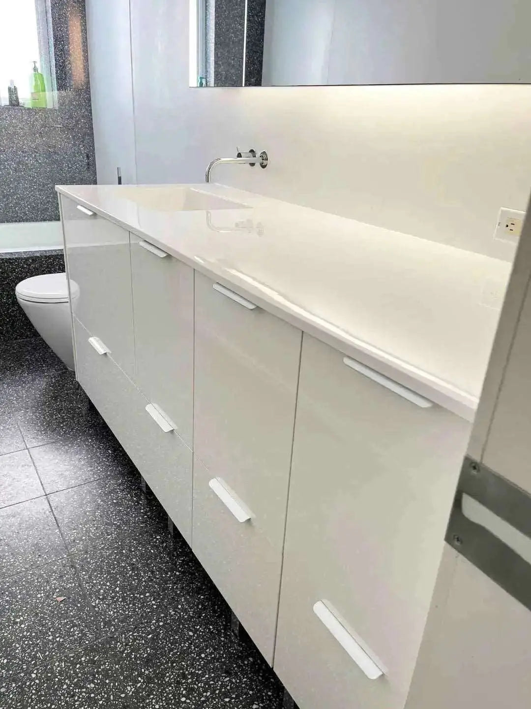 Custom floor mounted white glossy lacquered bathroom vanity 76 x 25 inches. 8 drawers + 2 pull down drawers. Custom Resin gelcoat countertop one sink to left. White